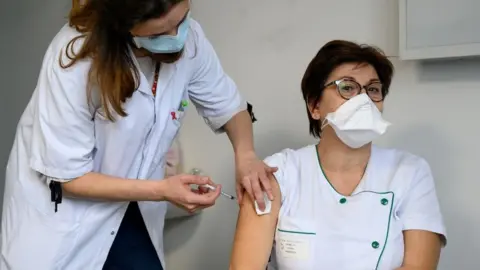 Getty Images Picture of French woman being vaccinated