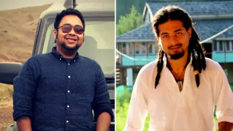 Abhijeet Nath (left), wearing a blue shirt and sporting sunglasses, smiles for a photo, standing in front of a black SUV; Nilotpal Das, wearing a white kurta, a pendant tied to a thread around his neck and sporting dreadlocks, poses for the camera, behind him one can see a turquoise-coloured building. 