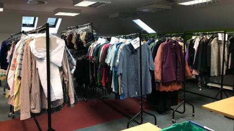 Rails of clothing inside warehouse run by Ruksak 45218 in Trowbridge