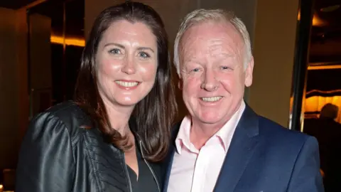 Getty Images Claire Nicholson and Les Dennis standing together while guests at a theatre in 2018
