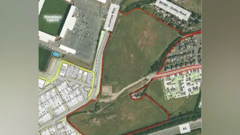 Omega Architects An aerial image of a green field space next to a green football pitch and car park. There is a red line around the field. Labels on its sides read "Loverose Way" and "B4380 Oteley Road"