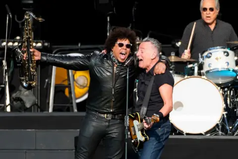 Matthew Baker / Getty Images Bruce Springsteen (right) and Jake Clemons of the E Street Band