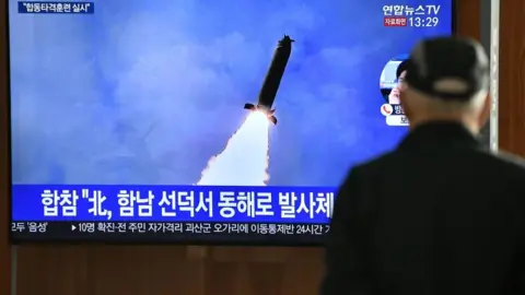 Getty Images A man watches a television news broadcast showing a file image of a North Korean missile test, at a railway station in Seoul on March 9, 2020. - Nuclear-armed North Korea on March 9 fired what Japan said appeared to be ballistic missiles, a week after a similar weapons test by Pyongyang. (