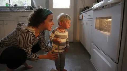 Getty Images woman and child look at oven