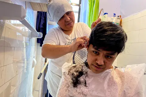  Ana Carmona Ana's mom cuts her brother Bernie's hair