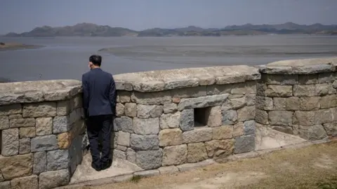 ED JONES / Getty A visitor on Ganghwa Island looking out to the North in April