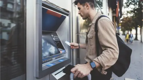 Getty Images Man by cash machine