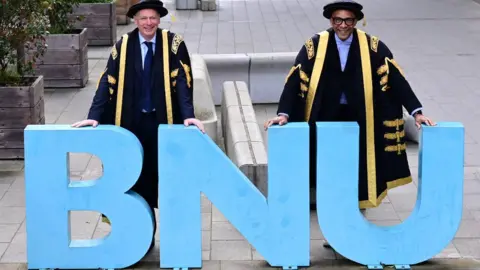 Matt Fowler Photography  Professor Nick Braisby and Jay Blades in front of a BNU sign