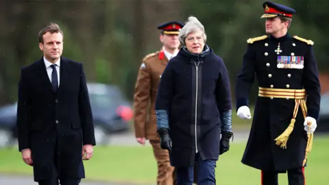 Reuters Theresa May and Emmanuel Macron