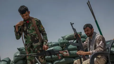 Getty Images Iraqi PMF fighters on the Iraq-Syria border in Nineveh, Iraq in June 2017