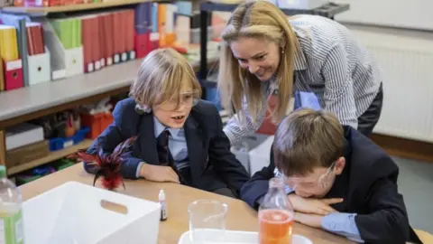 Kalpesh Lathigra Susanna Naylor helping pupils make lava lamps at Christ Church Cathedral School