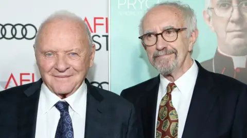 Getty Images Hopkins and Pryce as the two popes sitting together