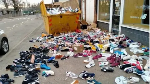 Outrage as hundreds of New Balance trainers found in skip