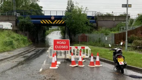Luke Deal/BBC Road flooded under a bridge on Sproughton Road, Ipswich.
