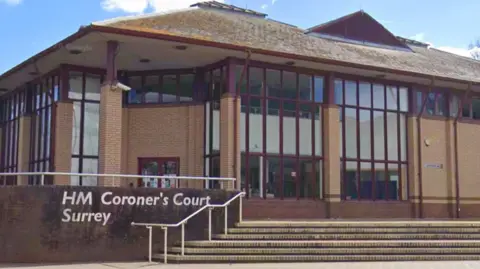 Surrey Coroner's Court is a red brick building with lots of windows and a double flight of steps at the entrance