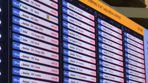 Reuters A board shows information on cancelled flights, after an Air Canada Express jet collided with a ground vehicle 