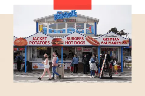 Getty Images People queue outside a fast food kiosk on the promenade in Skegness