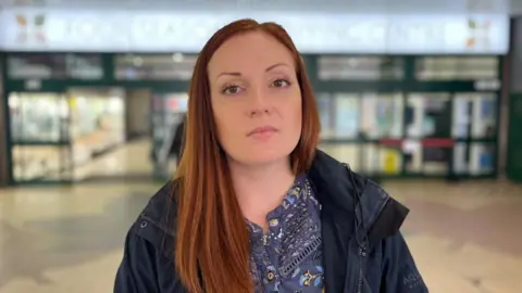 Felicity Benyon, stood in front of the Four Seasons Shopping Centre.