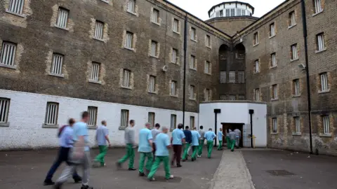 Prisoners return from their jobs to their wings for lunch at Wandsworth prison.