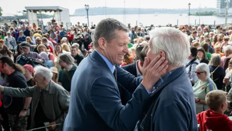 Rob Norman/Plaid Cymru Two men speak in front of a big crowd of people