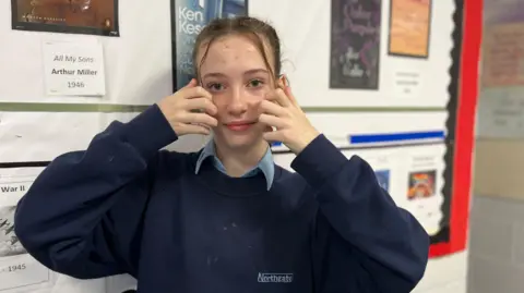 Jon Wright/BBC Lillie spelling out "cat" in BSL