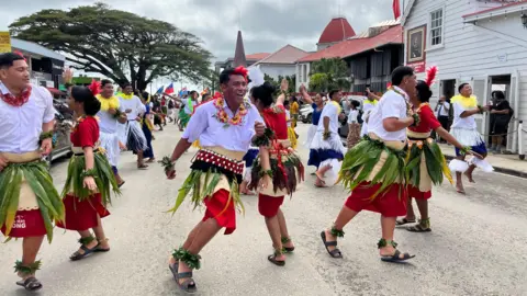 BBC/ Katy Watson A parade where locals dance 