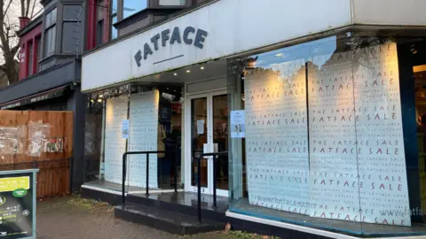 Front of FatFace store with closing down notice and sale signs