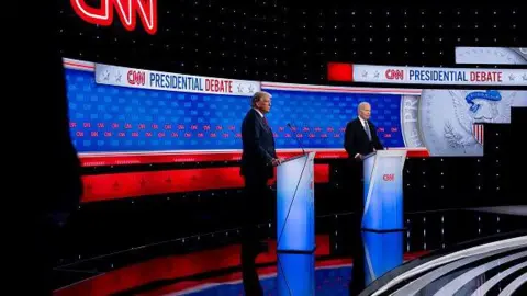  Andrew Harnik/Getty Images Former US President Donald Trump and US President Joe Biden stand on the debate stage