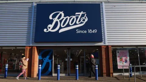 People walk past the Boots store in Stoke-on-Trent in the United Kingdom.