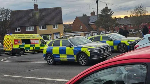 Adam Wilkes Two police cars and an ambulance at the scene on Ripon Drive.