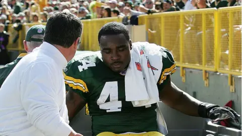 Getty Images Najeh Davenport leaves the football field injured