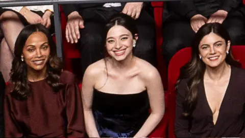 AMPAS Zoe Saldaña, Mikey Madison and Monica Barbaro in the 97th Oscars nominees dinner class photo