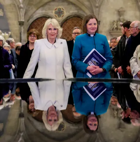 Chris Jackson / Getty Images Camilla stood in front of the reflecting pool in Salisbury Cathedral
