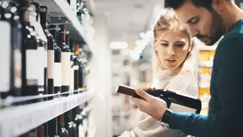 Getty Images Couple buying wine