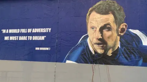 Cameron Davidson/BBC Damaged mural of Rob Burrow in Leeds