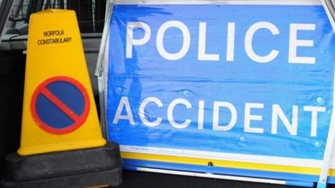A Norfolk police accident sign and cone