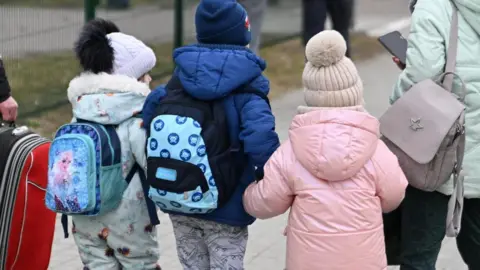 EPA Three children arriving at a border