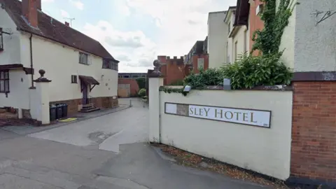 The entrance and sign to the Allesley Hotel. Part of the sign on the right of the picture is missing.