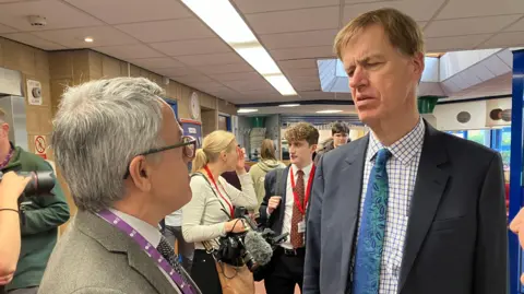 The principal of Loughborough's Sense College Gary Hyndman talks to Disabilities Minister Sir Stephen Timms in a busy college reception