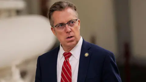 Republican Andy Ogles in a suit and red tie 