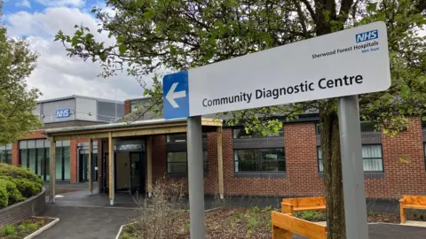 Exterior of diagnostic centre, showing nameplate