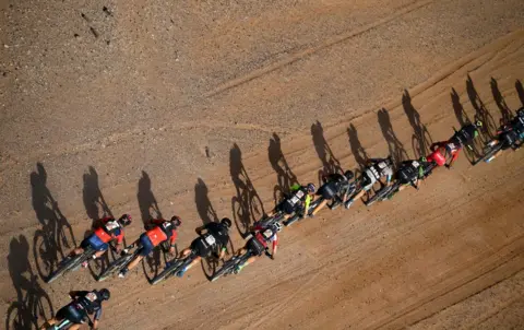 AFP Competitors ride their bikes during Stage 4 of the 14th edition of Titan Desert 2019 mountain biking race between Merzouga and Mssici, in Morocco, on May 1, 2019