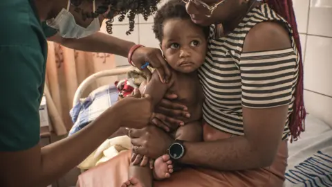 BBC A child being vaccinated