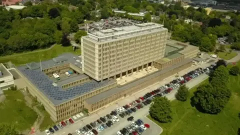 BBC An aerial view of County Hall, the headquarters of Norfolk County Council. It's a large multi-storey building surrounded by car parks.