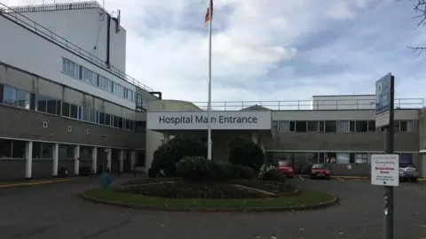 BBC Princess Elizabeth Hospital with a hospital main entrance sign and cars parked outside