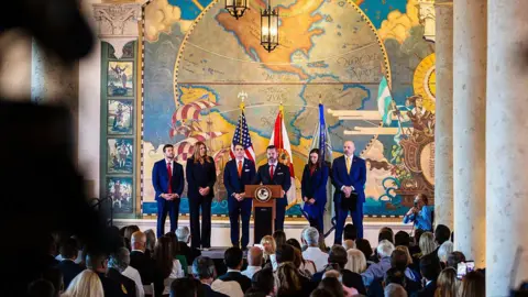 Getty Images James Uthmeier, Florida's attorney general, from left, Madeline Pumariega, president of Miami Dade College, Todd Blanche, acting US attorney general, US attorney Jason A. Reding Quiñones, Senator Ashley Moody, a Republican from Florida, and Christopher Raia, deputy director of the Federal Bureau of Investigation (FBI), during a news conference at Freedom Tower in Miami, Florida, US, on Wednesday, May 20, 2026