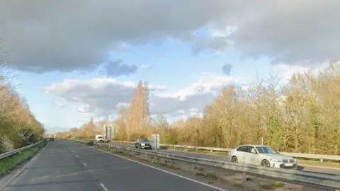 A dual carriageway road with cars on it.
