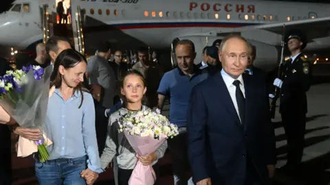President Vladimir Putin welcomes released Russian prisoners at tarmac 