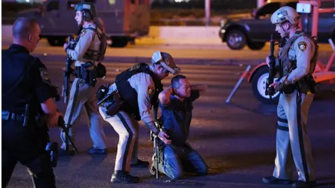 Getty Images police with man on knees