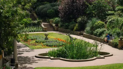 Tom Arber South Cliff Gardens in Scarborough, with lots of plants and flowers surrounded by pathways and ornate stone steps.